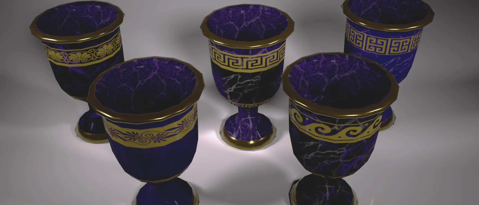 Four dark marble chalices with gold rims and Greek key patterns, made for Pandora's Party Box