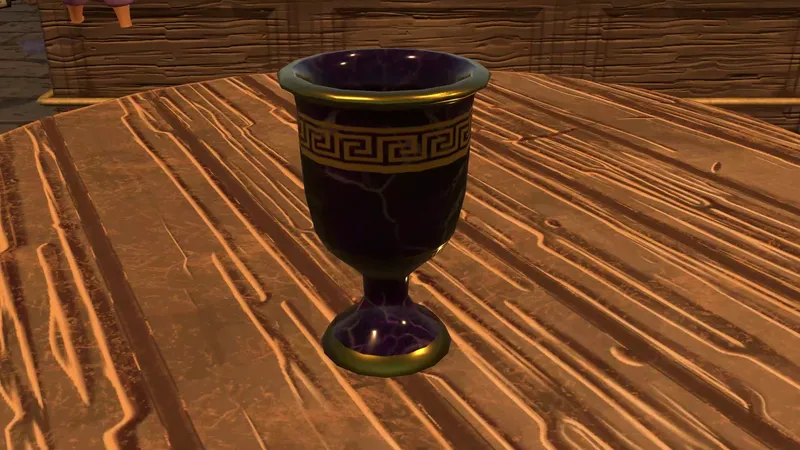 A dark goblet on a wooden table lit by warm light