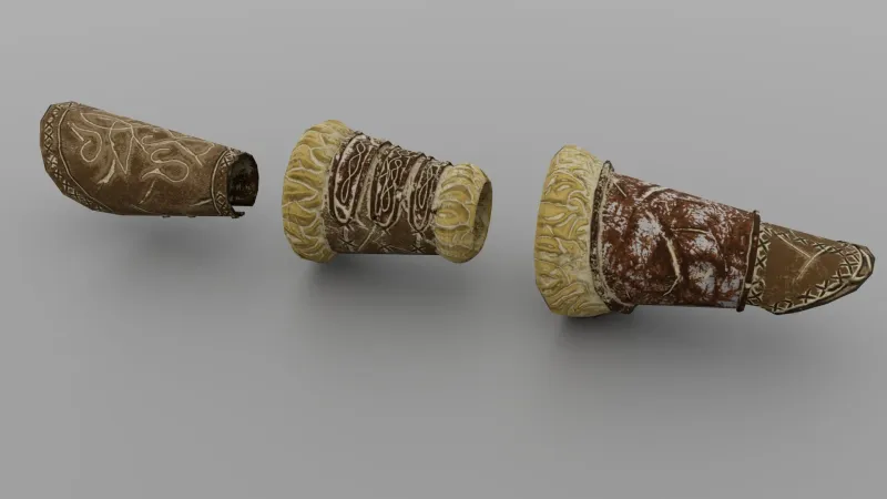 Three textured bracers with worn leather and cloth wraps