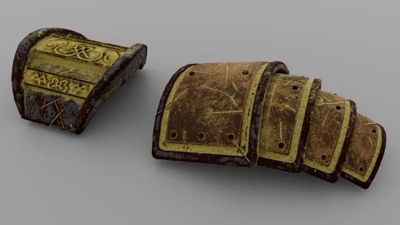 Two textured pauldrons with engraved patterns and scratched metal