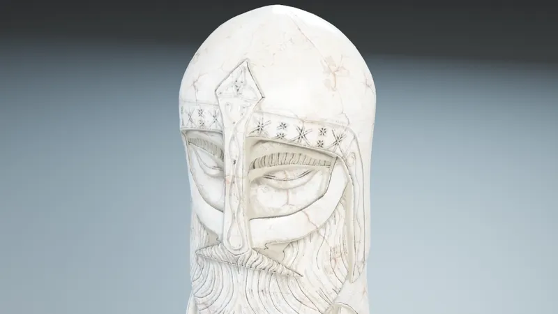 Close-up of the Thor Totem face, showing the helmet with star patterns, closed eyes and carved beard