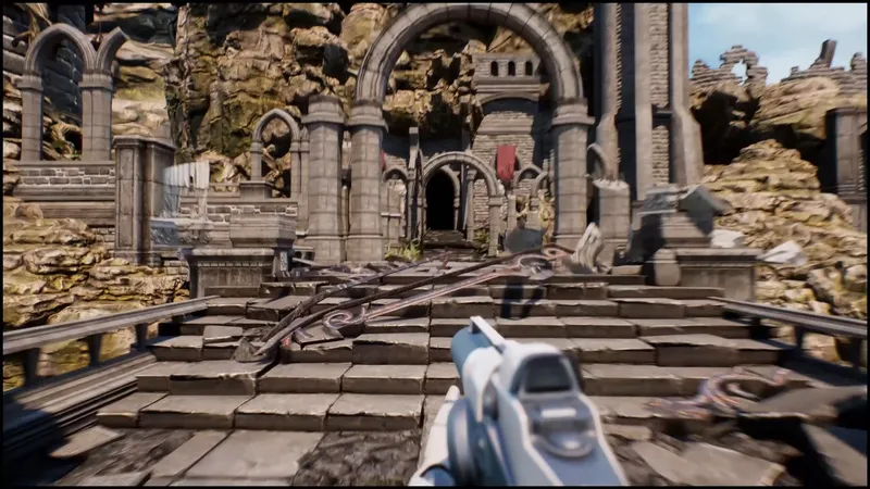 A first-person view of stone debris on stairs in front of a ruined arch